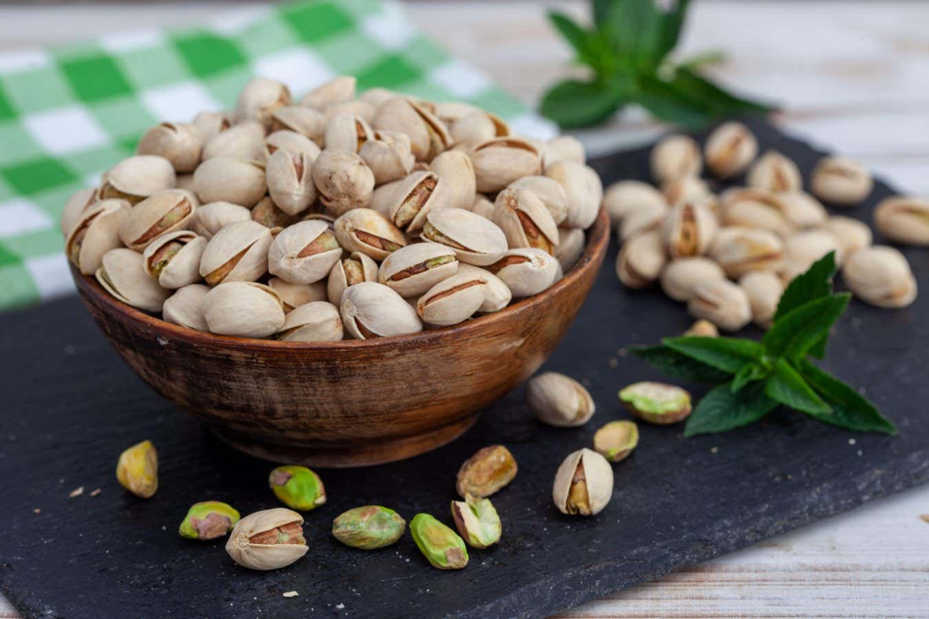 2X4A38G Roasted pistachio in bowl. Healthy snack, vegetarian food full of protein, beer snack.