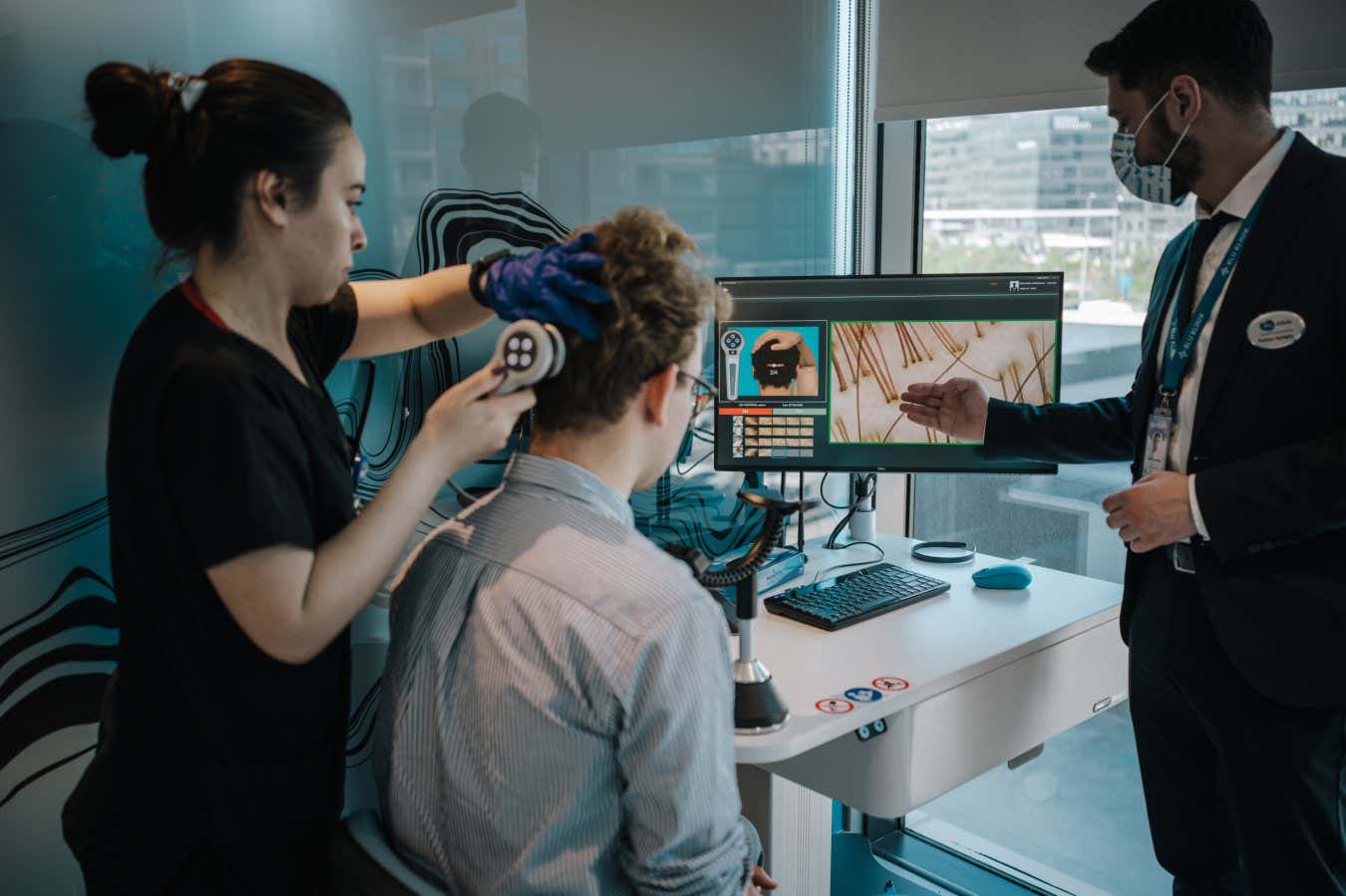 Members of the medical staff at the Elithair clinic conduct an artificial Intelligence analysis of Felix Hofmann's scalp and his hair roots.