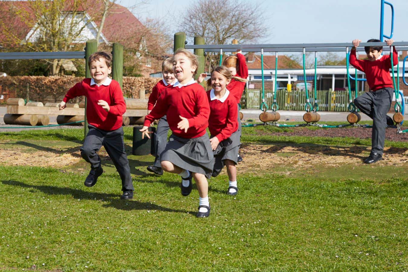 Elementary School Pupils Running Near Climbing Equipment Running Towards Camera